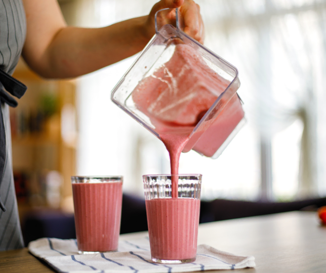 Healthy smoothie being poured from a blender