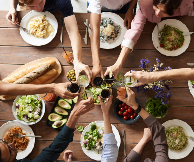 group of friends cheersing at a dinner party