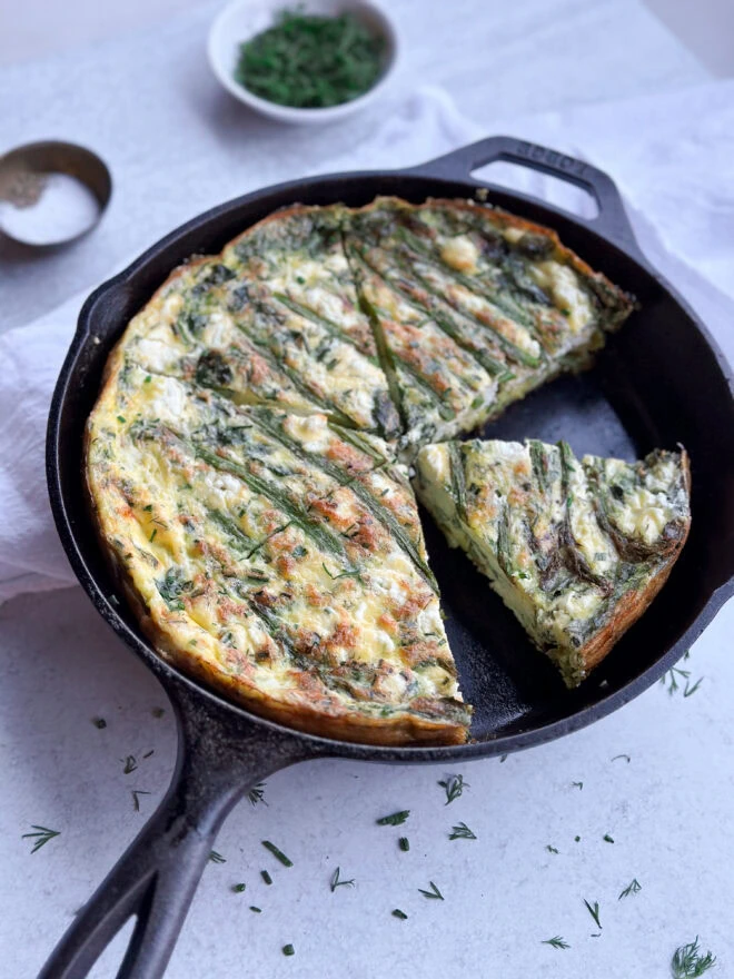 a cast iron pan with an Asparagus & Goat Cheese Frittata Recipe