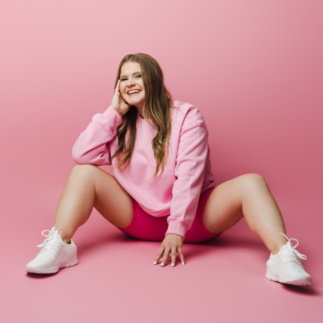 Image of a woman sitting in a studio looking accomplished